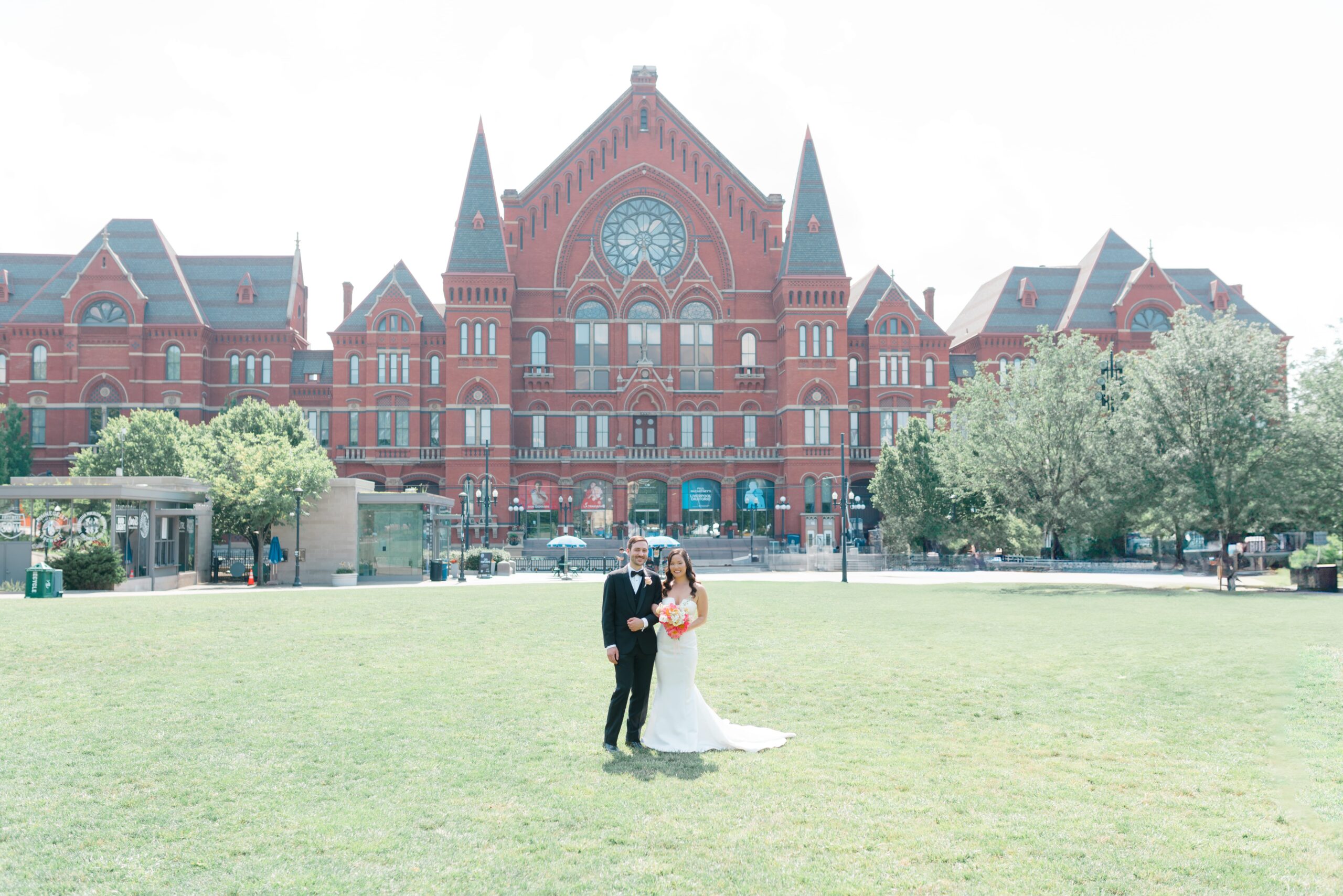 Bride and Groom posing in front of Cincinnati Music Hall.