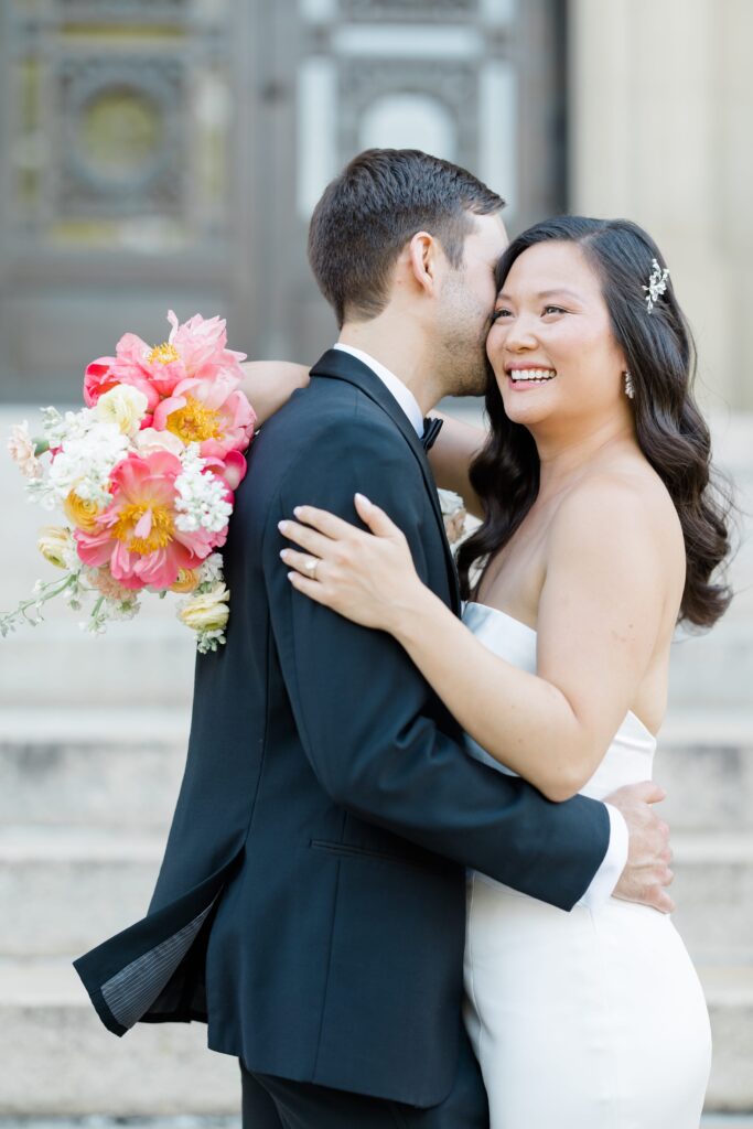 Bride and Groom posing in front of Memorial Hall in Cincinnati for their Cincinnati Music Hall wedding