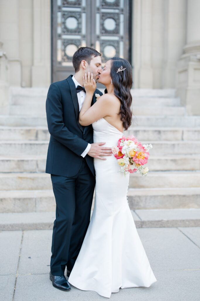 Bride and Groom posing in front of Memorial Hall in Cincinnati for their Cincinnati Music Hall wedding