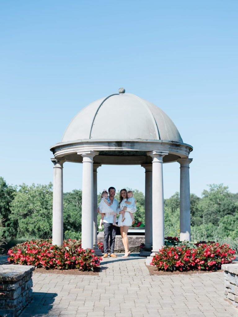 family posing at the pavilion at glenwood gardens 