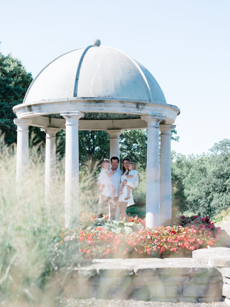 family posing at the pavilion at glenwood gardens 