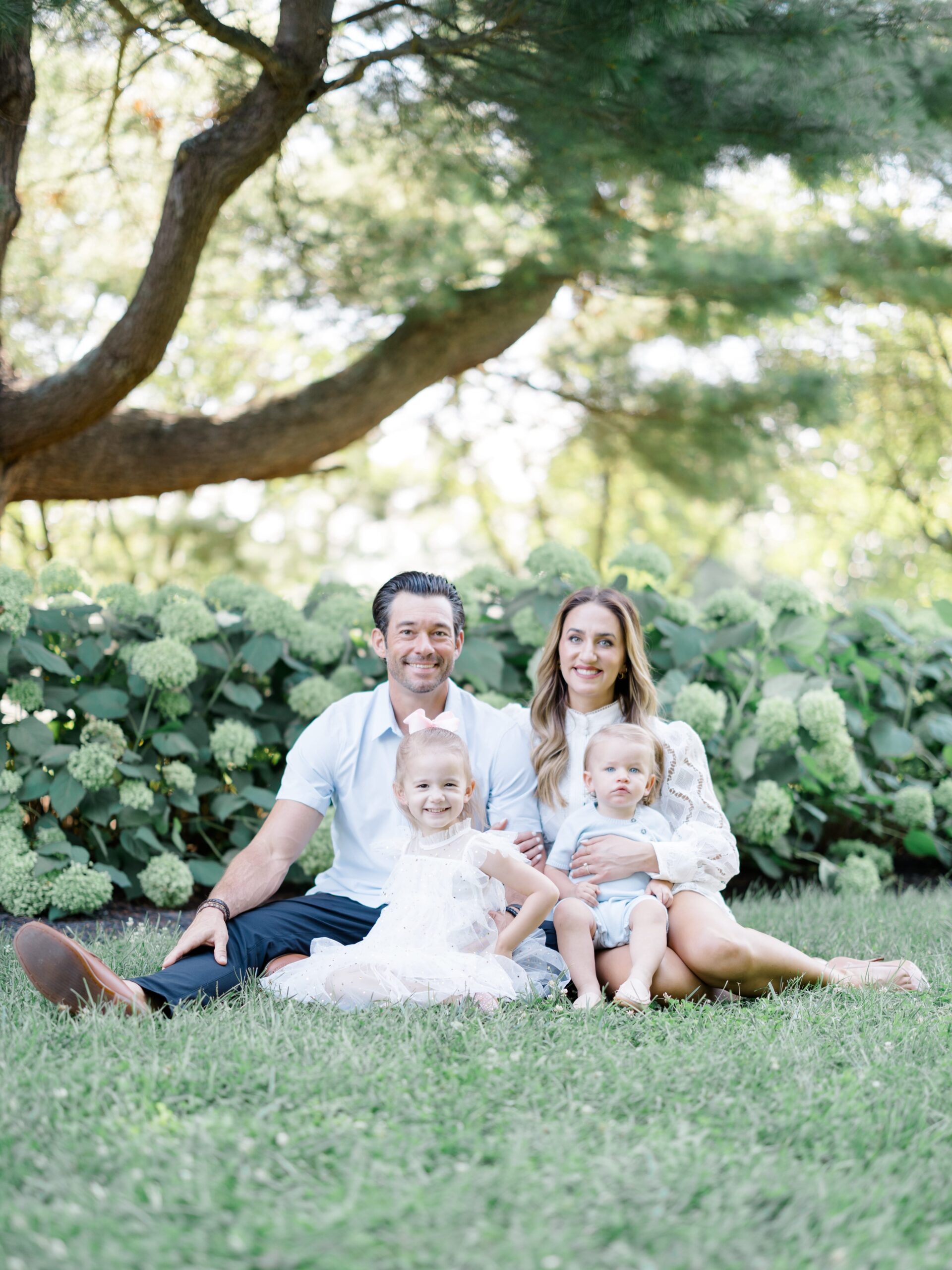 Family posing for a photo at Glenwood Gardens in Cincinnati, Ohio.