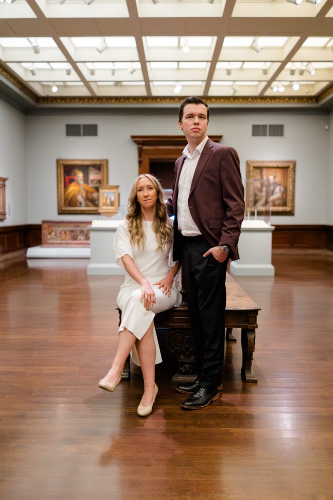 Engaged couple posing in front of artwork at the Cincinnati Art Museum.