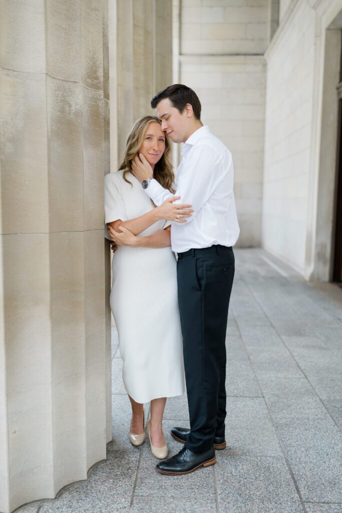 Engaged couple posing for a photo in front of the Cincinnati Art Museum.