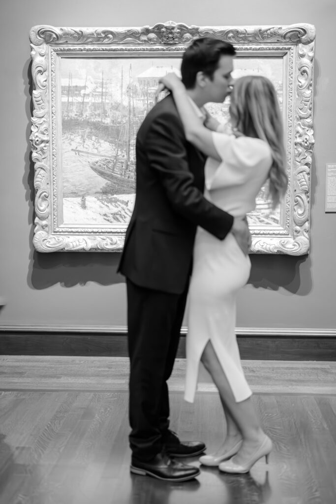 Engaged couple posing in front of artwork at the Cincinnati Art Museum.