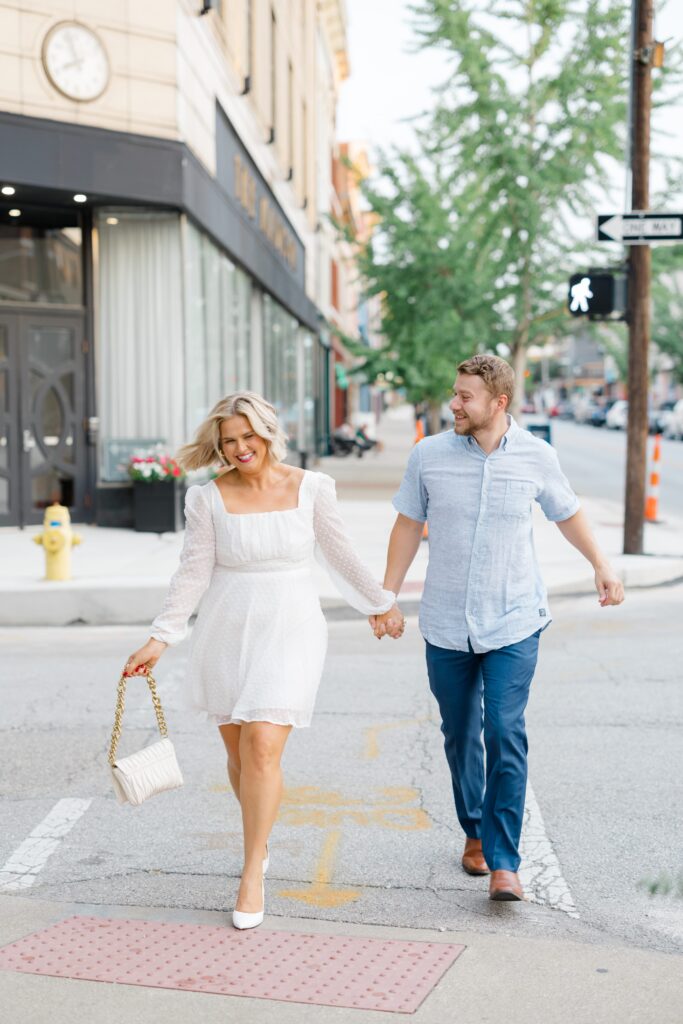 Engaged couple posing for a photo near Hotel Covington.