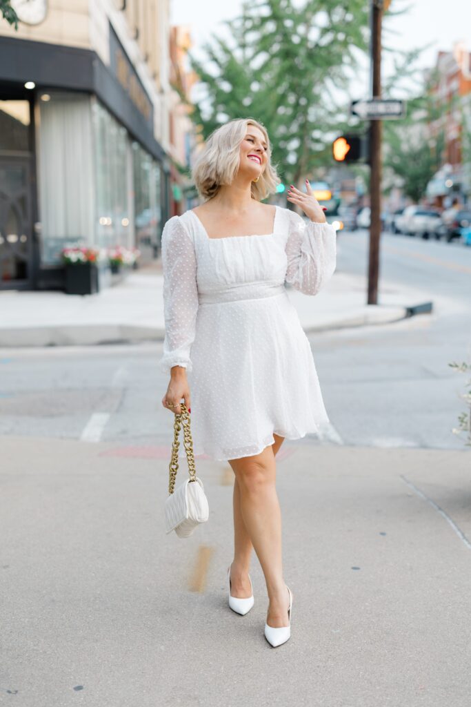 Bride posing for a photo in the street.