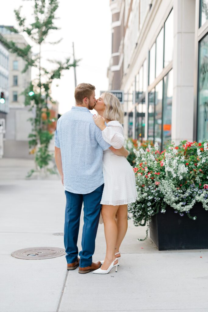 Engaged couple posing for a photo near Hotel Covington.