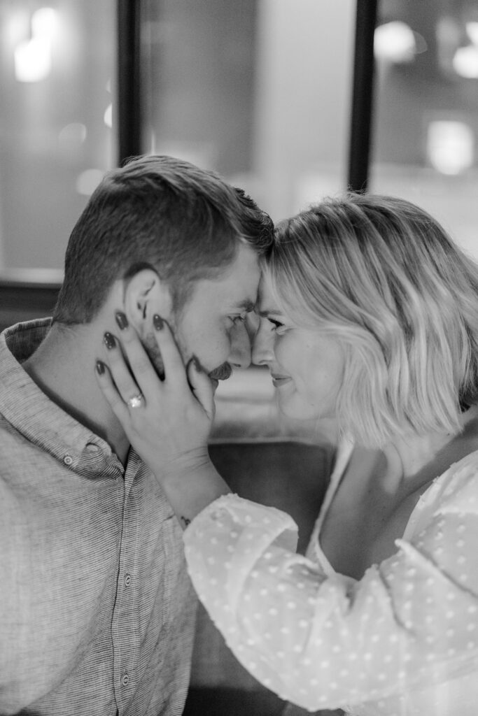 Engaged couple posing for a photo at Knowledge Bar in Hotel Covington.