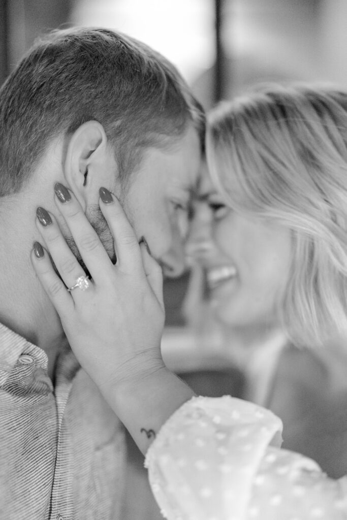 Engaged couple posing for a photo in Knowledge Bar in Hotel Covington.