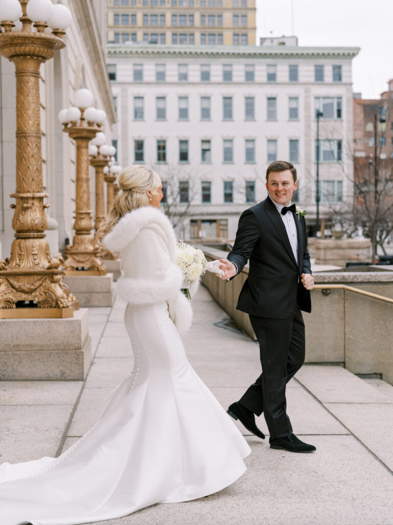 groom leading bride outside of Cincinnati Renaissance Hotel wedding venue