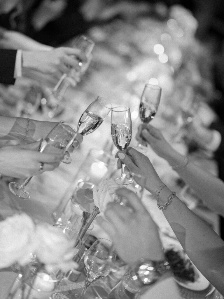 photo of wedding guests cheering with champagne 