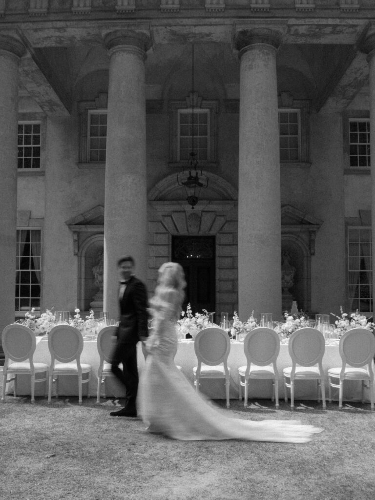 Bride walking beside reception table at The Swan House Atlanta wedding editorial